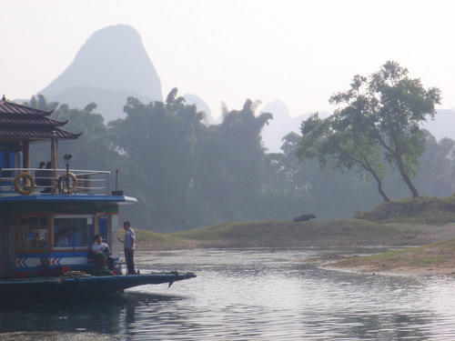 Boat coming in, Mountains, Water Buffalo.